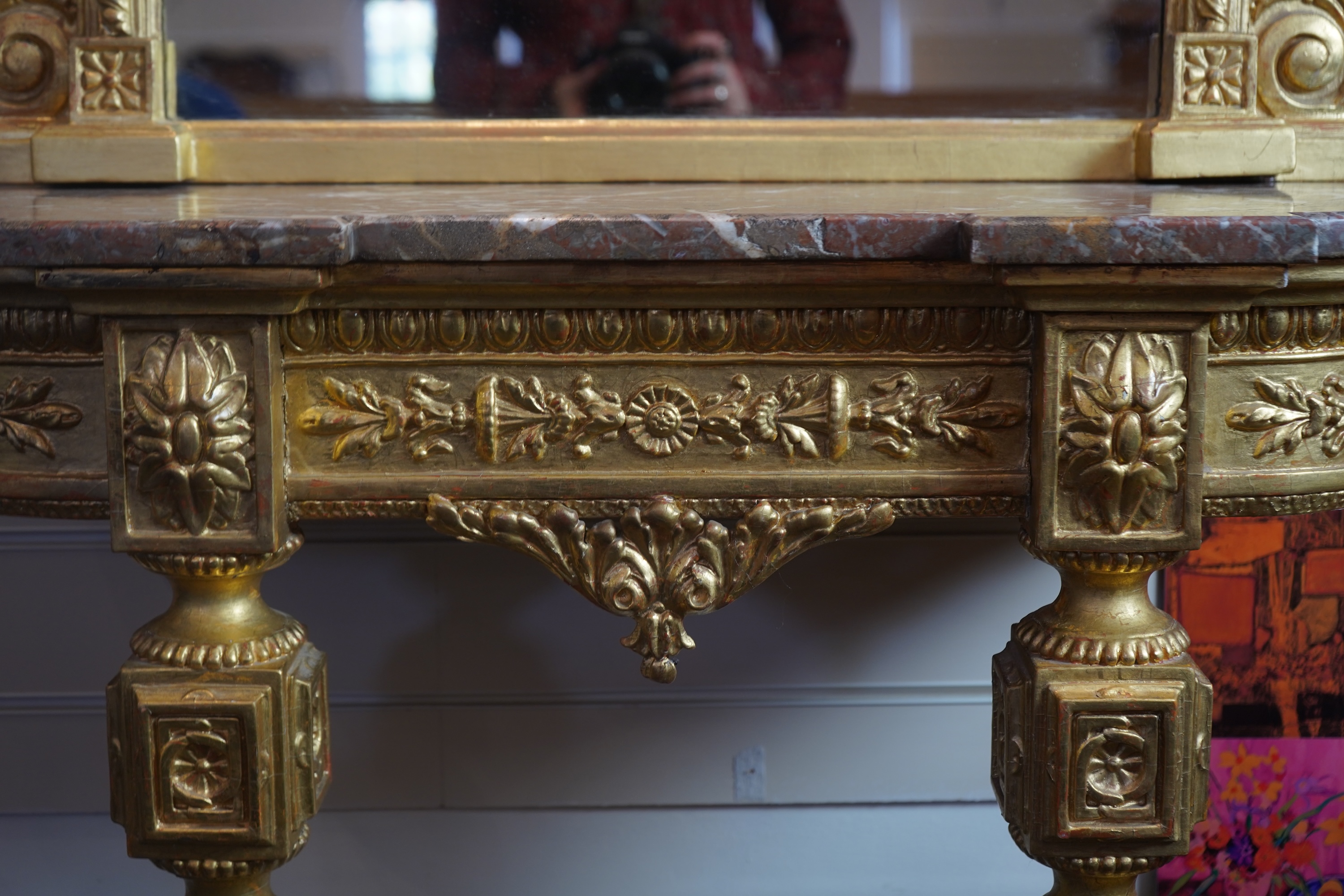 A pair of Louis XVI style giltwood and composition marble topped pier tables and mirrors